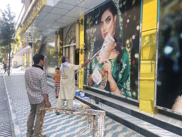 Afghan Taliban paint off images of women at beauty salons