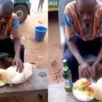 Shocking video of Nigerian man eating from the same plate with a hen