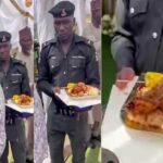 Police summons officer seen carrying a female VIP’s food tray in viral video